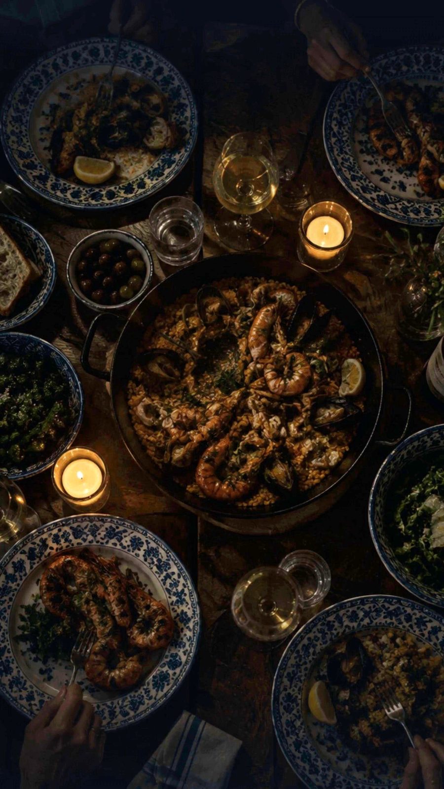 Mesa con arroz de marisco, gambas y velas, vista desde arriba
